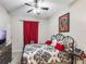 Bedroom featuring black iron bed frame, red accents and ceiling fan at 925 Counts Crest Cir, Apopka, FL 32712