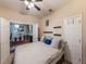 Comfortable bedroom showcasing hardwood floors, decor shelves, and an open office area at 925 Counts Crest Cir, Apopka, FL 32712