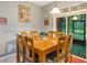The dining room boasts a wooden table with seating for eight, lit by a modern pendant light fixture at 925 Counts Crest Cir, Apopka, FL 32712