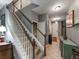 Bright hallway with white banister stairs, decorative console table and ceramic floors at 925 Counts Crest Cir, Apopka, FL 32712