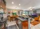 Open-concept kitchen featuring granite countertops, stainless steel appliances, and an island with a breakfast bar at 925 Counts Crest Cir, Apopka, FL 32712