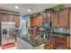 Kitchen featuring granite countertops, stainless steel appliances, an island with a breakfast bar and mosaic backsplash at 925 Counts Crest Cir, Apopka, FL 32712
