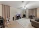 Bright living room featuring carpet floors, curtains, ceiling fan and television sets at 925 Counts Crest Cir, Apopka, FL 32712