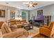 Spacious living room features comfortable leather furniture, hardwood floors, and ample natural light at 925 Counts Crest Cir, Apopka, FL 32712