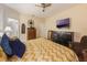 Bedroom featuring a ceiling fan, dresser, television and ensuite bathroom at 925 Counts Crest Cir, Apopka, FL 32712