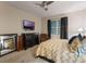 Bedroom featuring a ceiling fan, dresser, television and ensuite bathroom at 925 Counts Crest Cir, Apopka, FL 32712