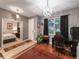 Inviting home office featuring hardwood floors, stylish chandelier, and natural light at 925 Counts Crest Cir, Apopka, FL 32712