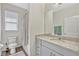 Well-lit bathroom with a granite-topped vanity, toilet, and shower-tub combo at 9456 Komika Ln, Winter Garden, FL 34787