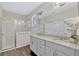 Elegant bathroom with double vanity, granite counters, and glass-enclosed shower at 9456 Komika Ln, Winter Garden, FL 34787