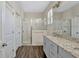 Bright bathroom features a glass-enclosed shower and a granite-topped vanity at 9456 Komika Ln, Winter Garden, FL 34787