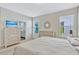 Comfortable bedroom with generous natural light and a glimpse into an en-suite bathroom at 9456 Komika Ln, Winter Garden, FL 34787