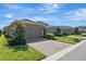 Residential home with a brick driveway, two-car garage, and well-manicured lawn at 9456 Komika Ln, Winter Garden, FL 34787