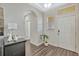 Welcoming foyer featuring wood floors, high ceilings, and neutral decor at 9456 Komika Ln, Winter Garden, FL 34787