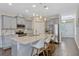 Modern kitchen boasts stainless steel appliances, granite countertops, and a large center island at 9456 Komika Ln, Winter Garden, FL 34787