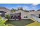 Rear exterior featuring a screened-in patio and green lawn at 9736 Heron Pointe Dr, Orlando, FL 32832