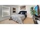 Bedroom featuring a dark blue headboard, tv, patterned bedding, and neutral walls at 9736 Heron Pointe Dr, Orlando, FL 32832