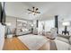 Bright living room with hardwood floors, a ceiling fan, and comfortable neutral-toned furniture at 9736 Heron Pointe Dr, Orlando, FL 32832