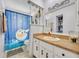 Charming bathroom with whimsical decor, featuring a unique shower curtain and ample counter space at 976 W Gaucho Cir, Deltona, FL 32725