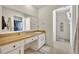 Bright bathroom featuring a single vanity, neutral tile flooring, and a shower with a white shower curtain at 976 W Gaucho Cir, Deltona, FL 32725