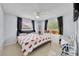 Cozy bedroom with natural light from two windows and a ceiling fan for added comfort at 976 W Gaucho Cir, Deltona, FL 32725
