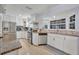 Updated kitchen showcases white cabinets, stainless steel appliances, granite counters, and a bright bay window at 976 W Gaucho Cir, Deltona, FL 32725