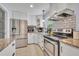 Well-lit kitchen features white cabinetry, granite countertops, and stainless steel appliances at 976 W Gaucho Cir, Deltona, FL 32725