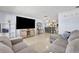 Comfortable living room with a large TV, open to the kitchen and dining area at 976 W Gaucho Cir, Deltona, FL 32725