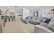 Spacious living room with plush seating, tile floors, and an open view of the kitchen and dining areas at 976 W Gaucho Cir, Deltona, FL 32725