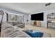 Bright and airy living room with a large bay window, comfortable seating, and modern entertainment center at 976 W Gaucho Cir, Deltona, FL 32725