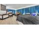 Spacious sunroom with a bed, crib, and couch, lit by natural light filtering through the window coverings at 976 W Gaucho Cir, Deltona, FL 32725