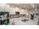 Bright kitchen featuring white cabinetry, stainless steel appliances, granite countertops, and modern pendant lighting at Tbd Royal Trails Rd, Eustis, FL 32736