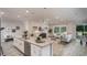 Airy living space featuring an island with sink, stainless appliances, and an open floor plan leading into the living room at Tbd Royal Trails Rd, Eustis, FL 32736