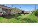Expansive backyard featuring a covered patio, lush green lawn, and potential for outdoor activities at 10215 Park Estates Ave, Orlando, FL 32836