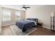Cozy bedroom with hardwood floors, two windows and a ceiling fan at 10215 Park Estates Ave, Orlando, FL 32836