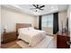Bright bedroom featuring a ceiling fan, tray ceiling, and natural light from the large window at 10215 Park Estates Ave, Orlando, FL 32836