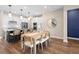 Open concept dining room with view into kitchen, featuring wood floors and pendant lighting at 10215 Park Estates Ave, Orlando, FL 32836