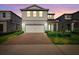 Charming two-story home with a brick driveway and lush landscaping at 10215 Park Estates Ave, Orlando, FL 32836