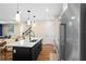 Modern kitchen with stainless steel appliances, a kitchen island, and pendant lighting at 10215 Park Estates Ave, Orlando, FL 32836