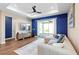 Open living room with a ceiling fan, sliding doors, and wood-look floors at 10215 Park Estates Ave, Orlando, FL 32836