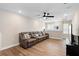 Cozy upstairs living room with wood floors, ceiling fan and large windows at 10215 Park Estates Ave, Orlando, FL 32836