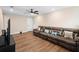 Spacious living room with wood floors, ceiling fan, television and comfortable sofa at 10215 Park Estates Ave, Orlando, FL 32836