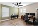 Home office features wood floors, two windows, desk, and musical keyboard at 10215 Park Estates Ave, Orlando, FL 32836