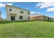 Spacious backyard showcasing a well-maintained lawn and the home's exterior with ample natural light at 1068 Brooklet Dr, Davenport, FL 33837