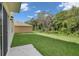 Expansive backyard featuring lush green grass and a treed backdrop, creating a serene outdoor space at 1068 Brooklet Dr, Davenport, FL 33837