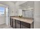 Bright bathroom with a granite double vanity, large mirror, and a glass-enclosed shower at 1068 Brooklet Dr, Davenport, FL 33837