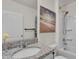 Bathroom with granite vanity, framed beach print, and shower-tub combination at 1068 Brooklet Dr, Davenport, FL 33837