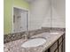 Bathroom featuring dual sinks with granite countertops and dark wood cabinets at 1068 Brooklet Dr, Davenport, FL 33837