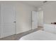 Neutral-toned bedroom featuring a white bedspread, closet, and dresser at 1068 Brooklet Dr, Davenport, FL 33837