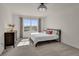 Sunlit bedroom with a modern chandelier, stylish dresser, and a large window at 1068 Brooklet Dr, Davenport, FL 33837