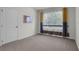 Bright bedroom features neutral carpet, a large window with decorative curtains, and a white door at 1068 Brooklet Dr, Davenport, FL 33837